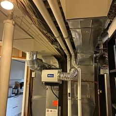 Completed furnace venting and mechanical-room connections for the Calgary installation